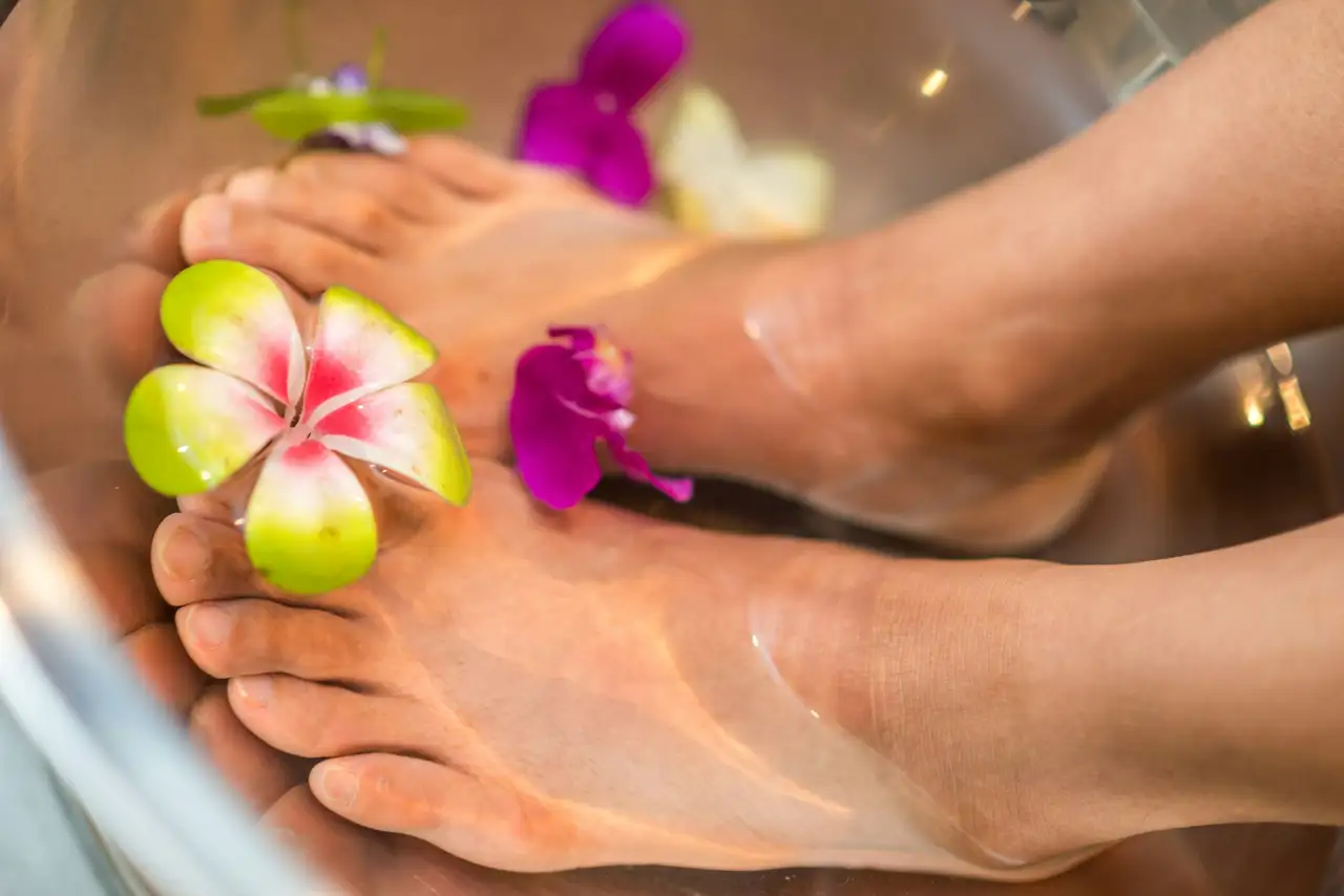 Feet in water with orchid flowers